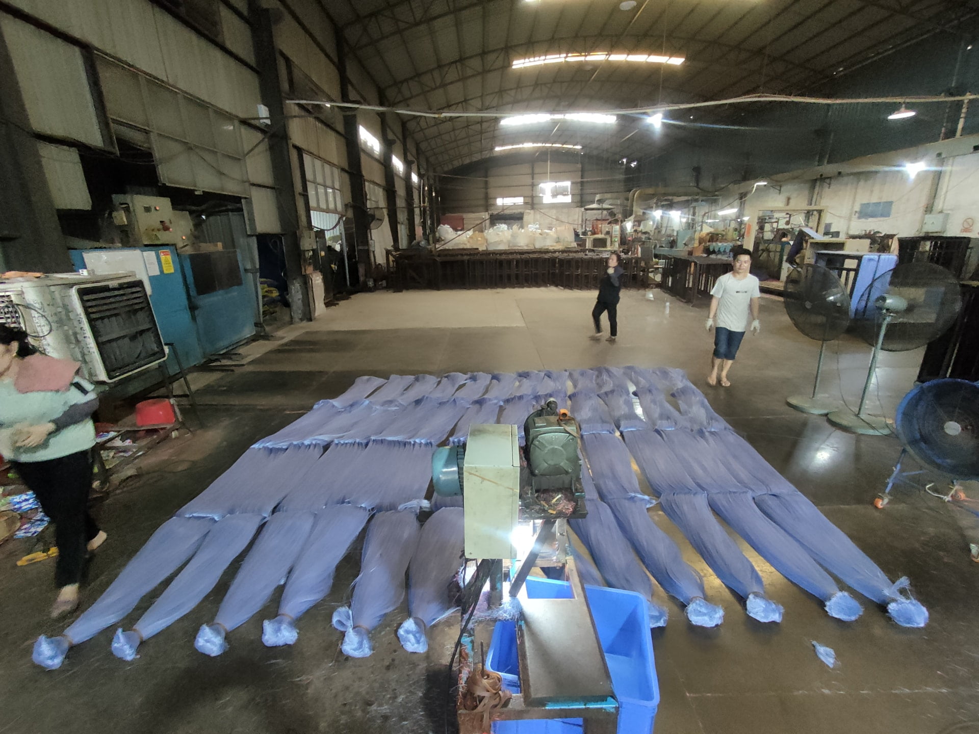 Factory floor where buyers review broom filament production